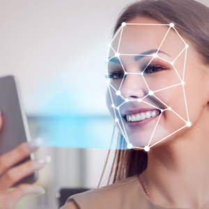 Illustration of a smartphone scanning a face with AI-powered facial recognition technology using deep machine learning.